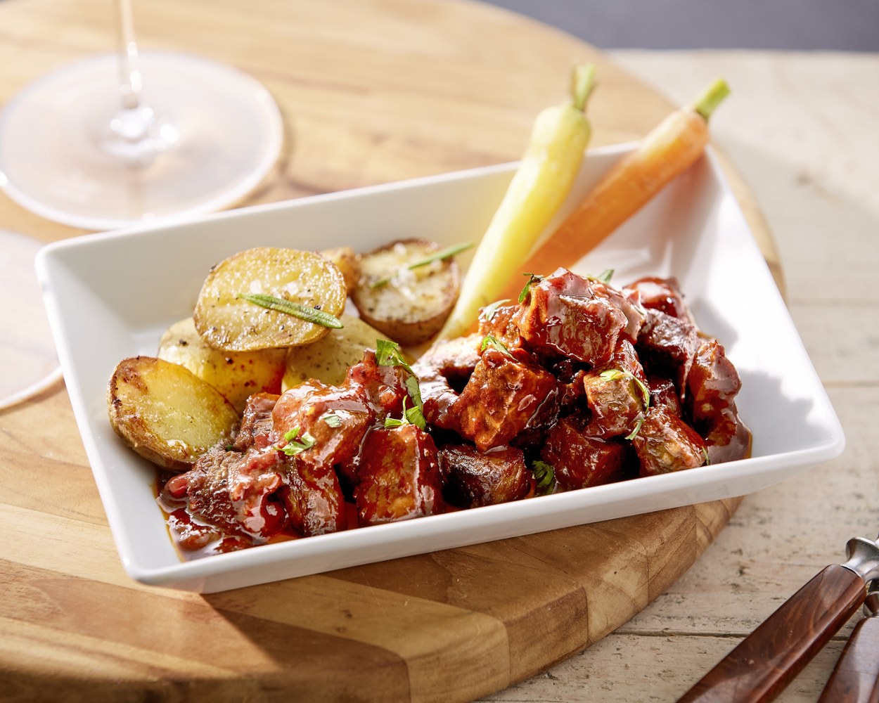 Sauced braised whole-cut dish with roasted potatoes and carrots